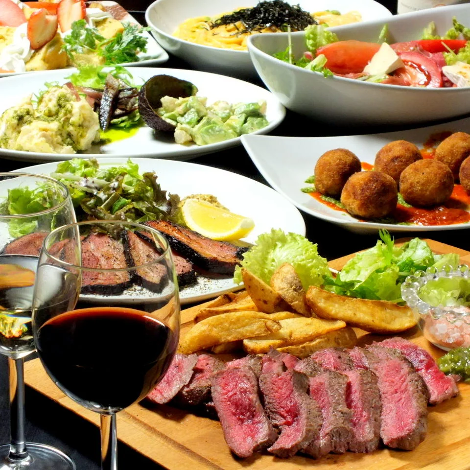 Cafe & Bar Swellの肉料理、前菜、グラスドリンクが並ぶテーブル